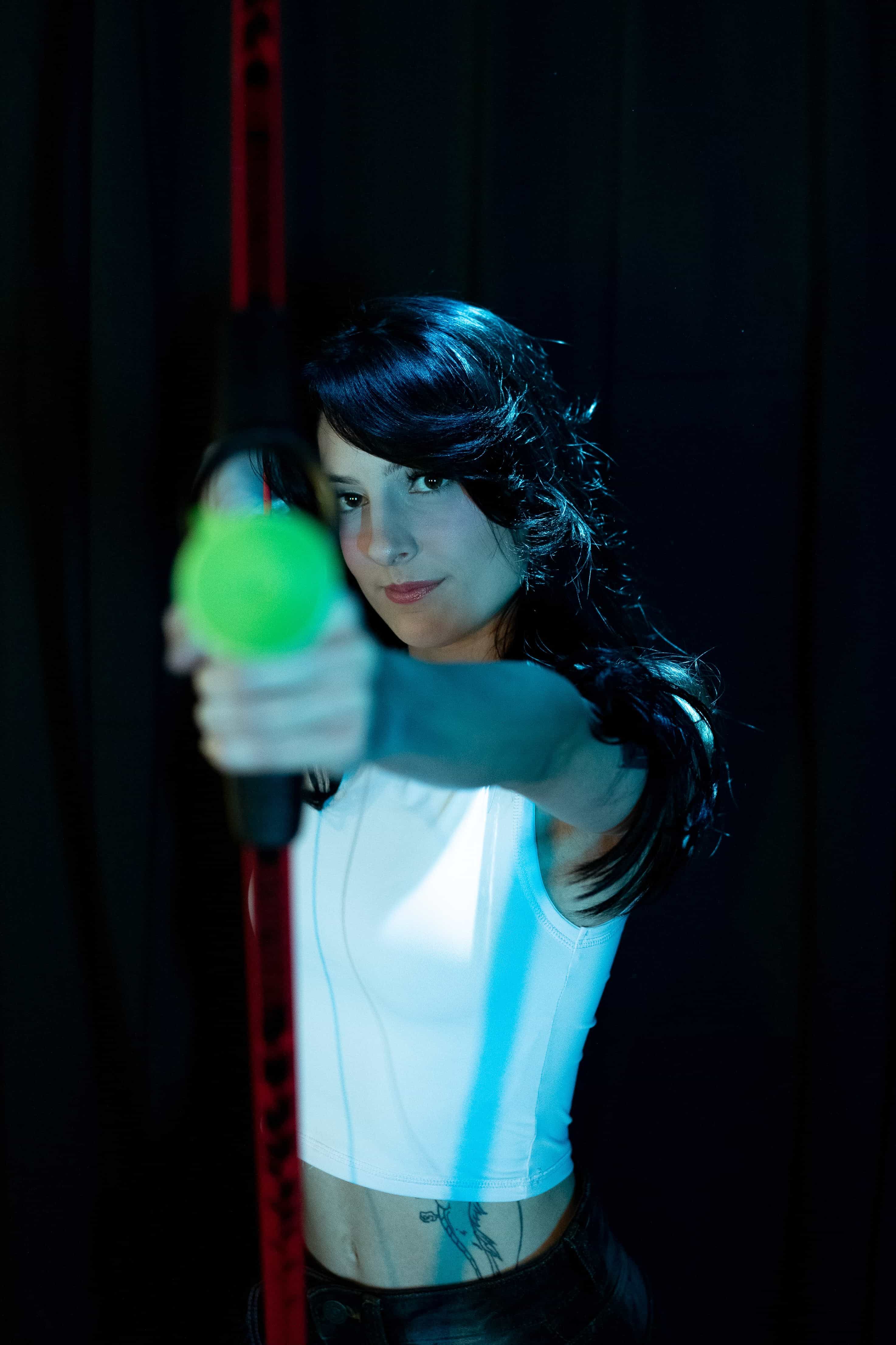 Teilnehmerin zielt mit Pfeil und Bogen